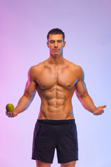 Happy man athlete with dumbbell isolated on pink background. Gym full body workout. Muscular man...