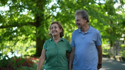 Happy senior couple walking together in afternoon walk