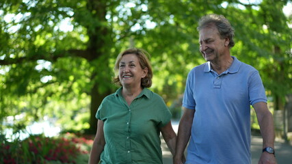 Obraz premium Happy senior couple walking together in afternoon walk