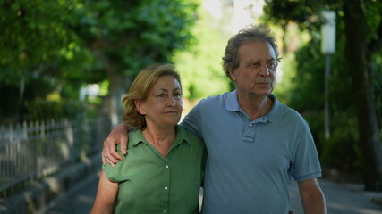 Obraz premium Happy senior couple walking together in afternoon walk