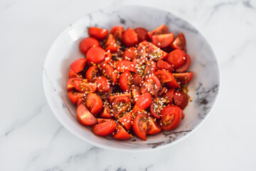 fresh ripe cherry tomatoes cut into cubes seasoned with olive oil balsamic vinegar and dukkah,...