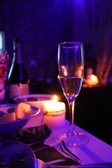 A glass of champagne and a festive table. New Year New Years party Holiday Birthday Wedding festive background banner panorama greeting card.