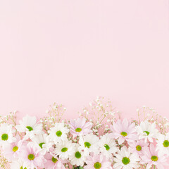 Creative pastel spring arrangement made of flowers on a pink background. Minimal floral concept with copy space. Wedding, Easter or Mother's Day inspiration.