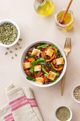 Salad with pumpkin, pomegranate, pecans and croutons. Healthy eating. Vegetarian food.