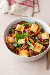 Salad with pumpkin, pomegranate, pecans and croutons. Healthy eating. Vegetarian food.