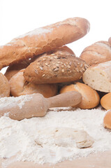 types of bread freshly baked with flour in a bakery