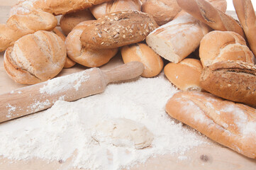 types of bread freshly baked with flour in a bakery