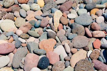Background texture of multi colored beach stones for background
