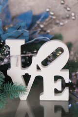 The word Love on the background of New Year, Christmas decorations. Vertical orientation