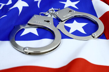 handcuffs on the flag of America, the concept of combating crime, corruption in the USA