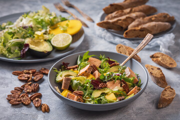 Baked salmon, mango and avocado salad with pecan nuts.