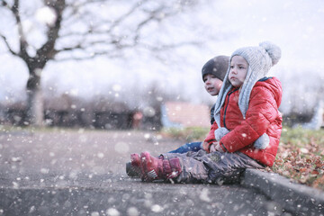 Kids walk in the park first snow
