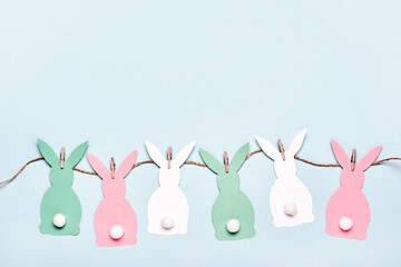 Easter background with diy paper rabbits garland and sweet easter eggs