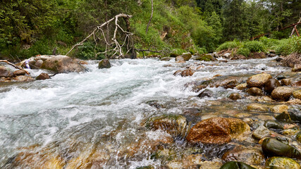 a mountain river flowing over rocks. blurred motion background