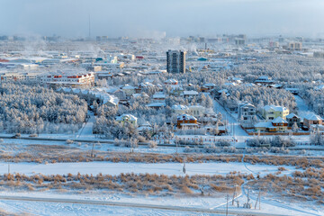 View from the hill to the Yakutsk city in the fog on a cold winter evening - 478309340