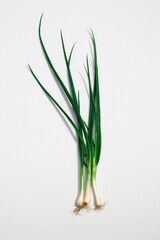 Three scallions are on a white background.