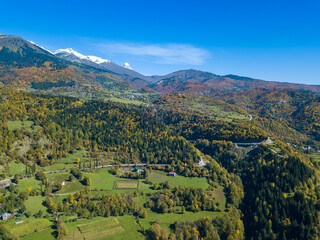 Fototapeta na wymiar Small mountain village of Svaneti on an autumn day, a view from a drone. Mountain landscape in Georgia. Nature background, aerial view. Shooting from a drone.