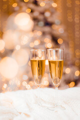 Champagne glasses on the background of a Christmas tree . Festive drinks. Alcoholic beverages.