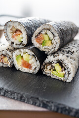 Sushi rolls. Homemade rolls with salmon, avocado and cucumber.