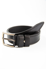 Fastened fashionable men's leather belt with dark matted metal buckle isolated on white background.