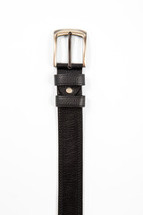 Fastened fashionable men's leather belt with dark matted metal buckle isolated on white background.