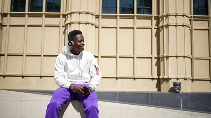 Portrait of young attractive stylish african american man model posing in casual clothes against neutral background looking sexy with afro hair. In People Youth Beauty and fashion concept.