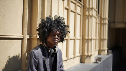 Portrait of young attractive stylish african american man model posing in casual clothes against neutral background looking sexy with afro hair. In People Youth Beauty and fashion concept.