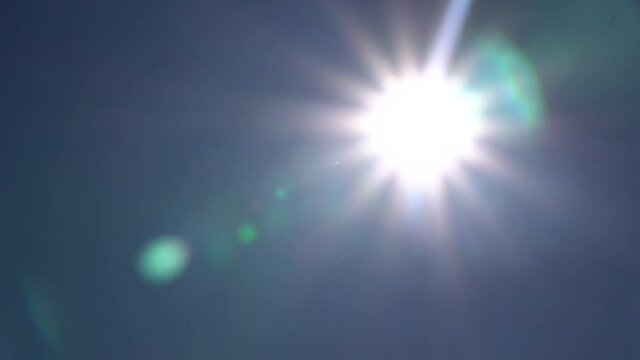 the sun shining in the blue sky thru the camera elements in 1080p 59.94p