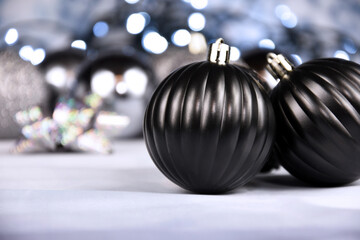 Decorative black and silver christmas balls with lights still life stock images. Elegant black decoration close up stock photo. Black ball ornament images - Powered by Adobe