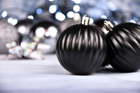Decorative black and silver christmas balls with lights still life stock images. Elegant black decoration close up stock photo. Black ball ornament images