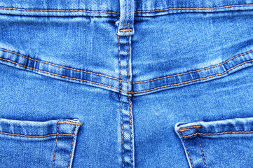 Fototapeta premium Flat lay, denim jeans leg seam detail, background texture.