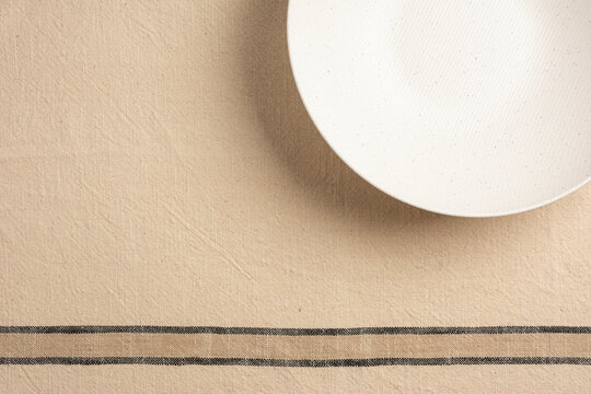 Empty plate on withe background table and napkin. Food background for menu, recipe. Flat Lay, top view for Table setting. Mockup for restaurant dish.	