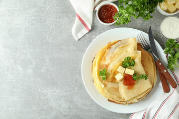 Concept of tasty food with crepes on gray textured background