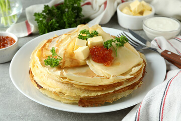 Concept of tasty food with crepes on gray textured background