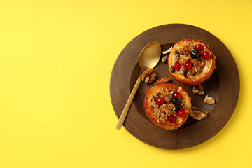 Concept of tasty food with baked apple on yellow background