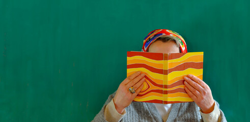 woman reading a book, education,reading, novel,unrecognizable person,free copy space teal background
