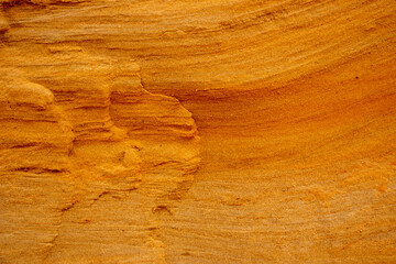 Textural sand, with  relief surface, multi-colored layers and different in size of granules, in outdoor sand career, after mining ore and sand for construction.