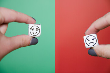 smiley face on green background and sad face on red background