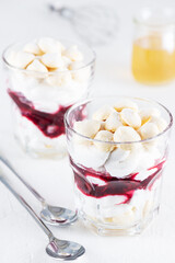 Vegan dessert with aquafaba meringue, coconut cream and cherry. Sugar and lactose free.