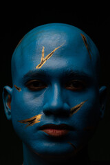 Bald man in blue makeup