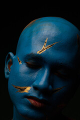 Bald man in blue makeup