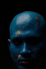 Bald man in blue makeup