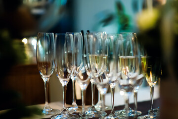 Сhampagne in wine glasses  at the party. Night event in restaurant.