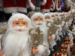 Bright, soft, New Year's toy Santa Claus. Preparing for the holiday, selling in a toy store. Santa Claus doll on a store shelf on Christmas Eve.