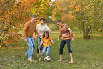 Fototapeta premium Portrait of big happy family playing football in park