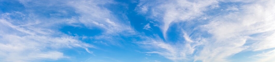 Panorama or panoramic photo of blue sky and white clouds or cloudscape. breathing concepts for billboard backdrop or background.