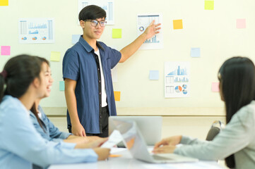 Young man presenting graph report with team, Business concepts.