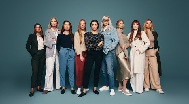 Group of strong independent women standing in a studio