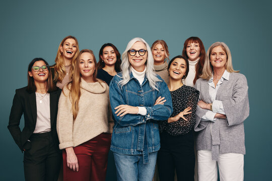 Portrait of happy women standing in a studio