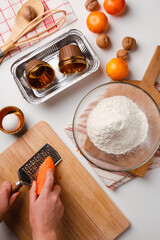 Preparation of dough for home orange and carrot cupcakes for Breakfast or for Holiday. Ingredients on the table - wheat flour, eggs, butter, sugar, salt. Recipe step by step.